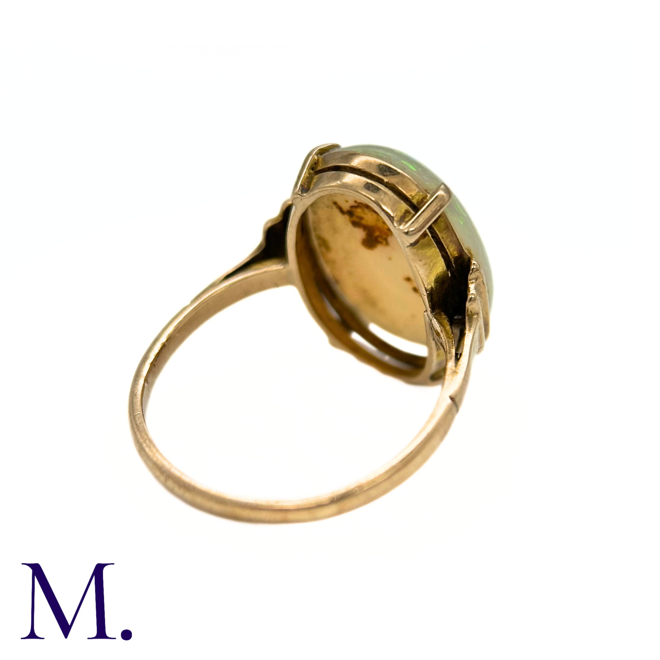 An Opal Ring in 9k yellow gold, set with a cabochon opal to stepped shoulders. Stamped 9ct. Size: - Image 6 of 7