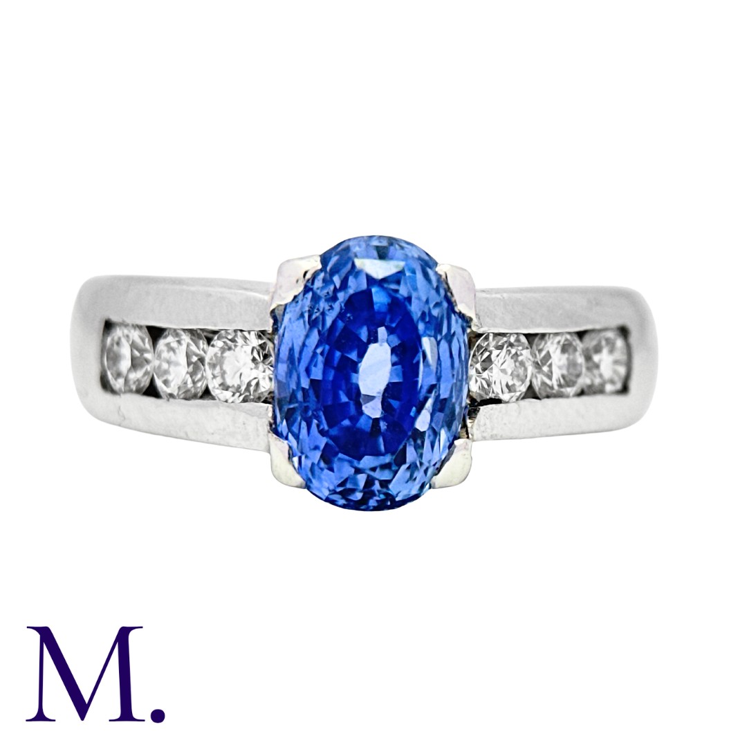 A Sapphire and Diamond Ring set with an oval cut sapphire weighing approximately 2.44ct (accompanied