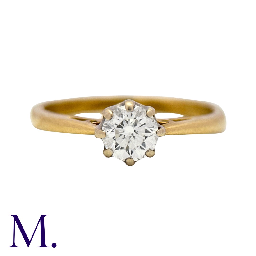 A Diamond Solitaire Ring in 18K yellow gold, set with a round brilliant diamond weighing