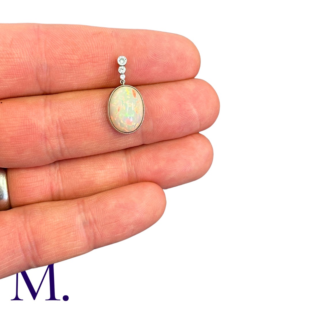 An Opal And Diamond Pendant in platinum, set with a principal cabochon opal of approximately 5.00cts