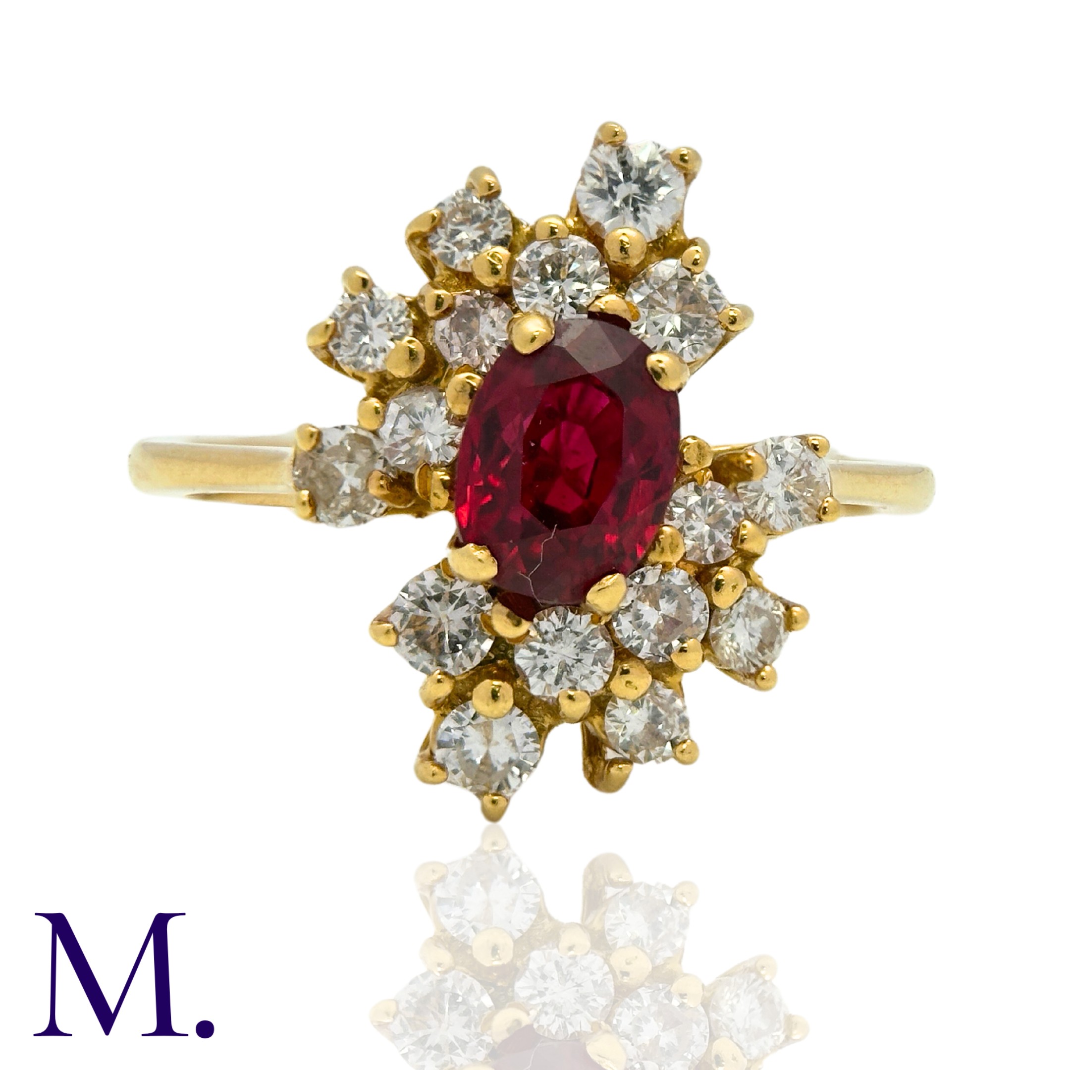 A Ruby and Diamond Ring in 18K yellow gold, set with an oval cut ruby of approximately 0.60ct to the