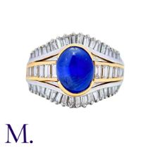 A Sapphire and Diamond Ring in platinum and 18K yellow gold, set with a cabochon sapphire of