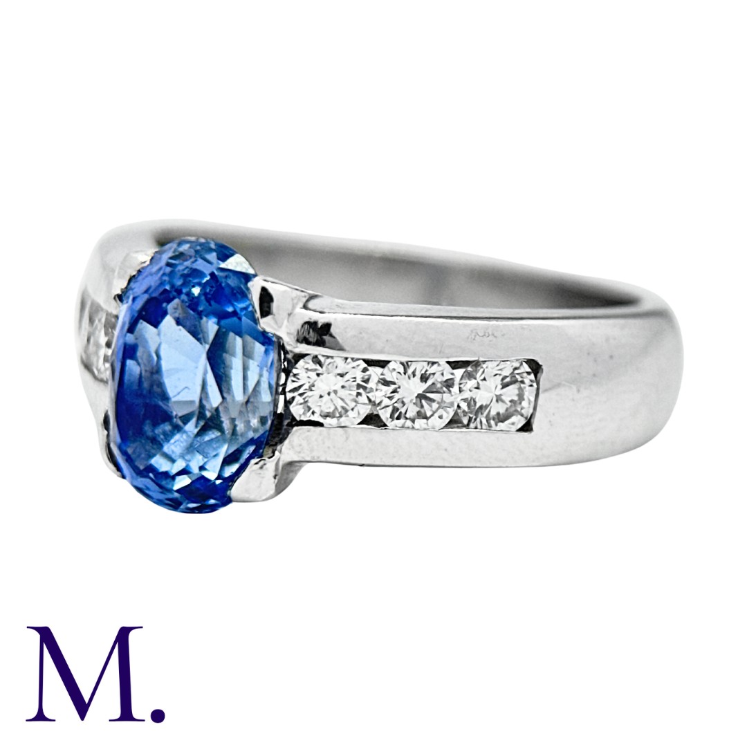 A Sapphire and Diamond Ring set with an oval cut sapphire weighing approximately 2.44ct (accompanied - Image 2 of 3