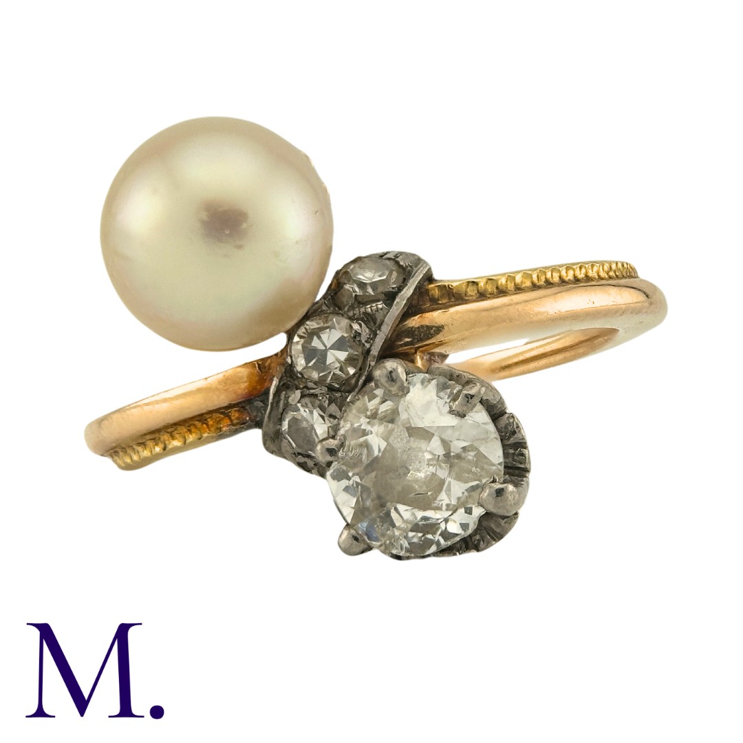 A Diamond And Pearl Toi Et Moi Ring in yellow gold, set with a principal old cut diamond of