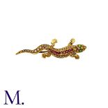A Gem-Set Salamander Brooch in 15K yellow gold, set with peridot, rubies (one deficient) and