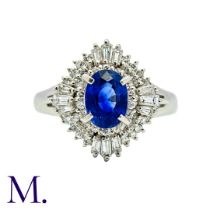 A Sapphire & Diamond Cluster Ring in platinum, set with an oval cut sapphire of approximately 1.06ct