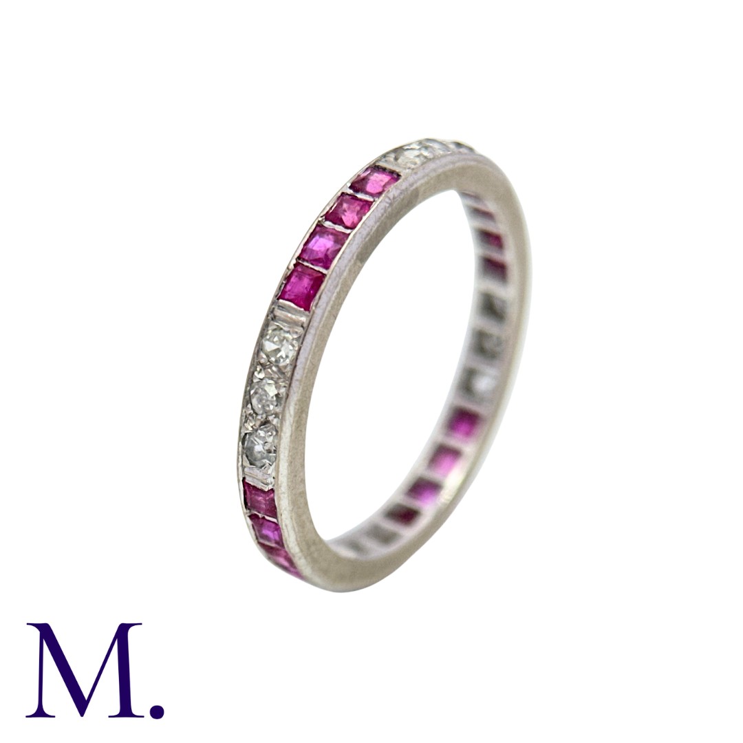 An Antique Ruby and Diamond Eternity Ring in white gold, set all around with alternating sections of