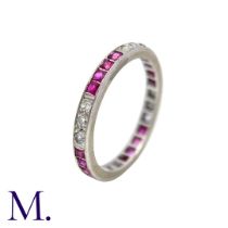 An Antique Ruby and Diamond Eternity Ring in white gold, set all around with alternating sections of