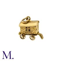 A Group of Gold Charms including a wagon, a camel, a handbag, a water carrier, a boot and a cross.