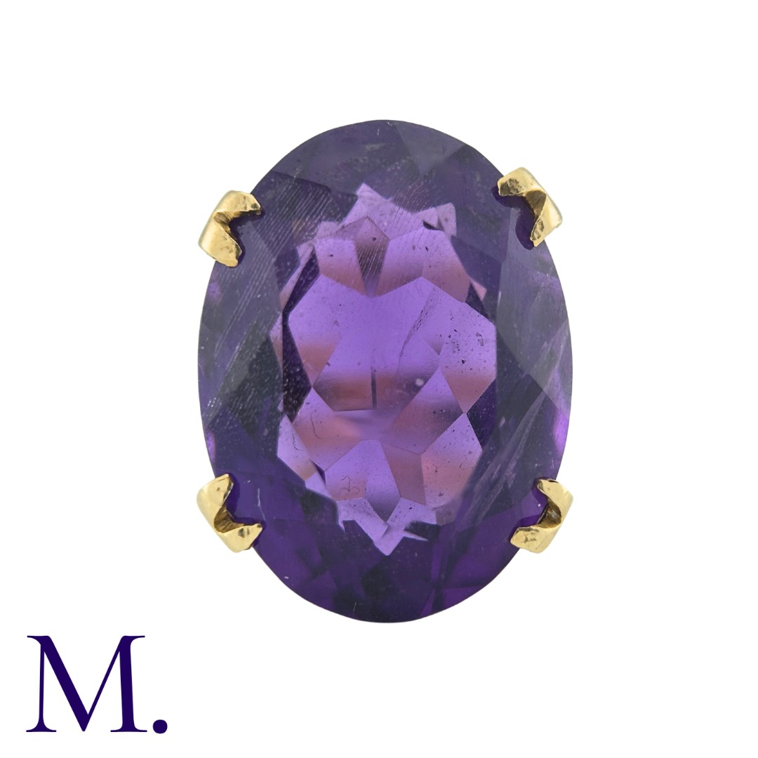 A Large Amethyst Ring in yellow gold, set with an oval cut amethyst weighing approximately 12.5ct.