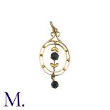 A Blue Stone Pendant in 9k yellow gold, the open work foliate and scrolling form set with a round