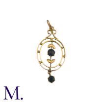 A Blue Stone Pendant in 9k yellow gold, the open work foliate and scrolling form set with a round