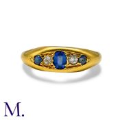 An Antique Sapphire & Diamond Gypsy Ring in 18K gold, set with an oval cut sapphire to the centre