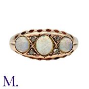 An Opal And Diamond Ring in 9k yellow gold, set with three cabochon opals punctuated by pairs of