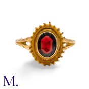 A Garnet Ring in 9ct yellow gold, set with an oval cut garnet to the centre. Band stamped '9ct'.