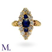 A Sapphire And Diamond Navette Ring in yellow gold, set principally with a trio of cushion cut