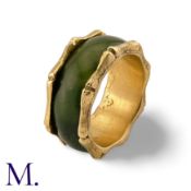 A Nephrite and Gold Ring in 14K yellow gold. The continuous nephrite band encircles the band with