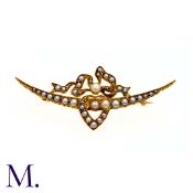 A Pearl Sweetheart Crescent Brooch in yellow gold, of crescent design with heart and bow. (