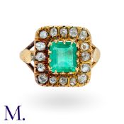 An Antique Emerald & Diamond Ring in gold set with an emerald-cut emerald (approx. 6x5mm) to the