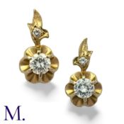 A Pair Of Diamond Drop Earrings in 14k yellow and white gold, each comprising a round cut diamond