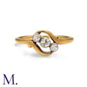 A Diamond Three Stone Ring in yellow gold, set with three round cut diamonds, to a twisted style