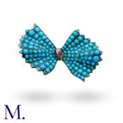 A Turquoise, Ruby And Diamond Bow Brooch in yellow gold, the bow motif set throughout with