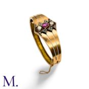 An Antique Ruby & Diamond Bangle in rose gold and silver, set with an oval-cut ruby and two old