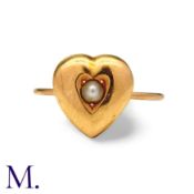 A Pearl Heart Ring in yellow gold, comprising a puffed heart motif set centrally with a pearl.