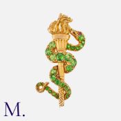 A Victorian Demantoid Garned Snake And Torch Brooch in yellow gold, comprising a demantoid garnet