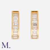 A Pair Of Diamond Hoop Earrings in 18k yellow gold, of hoop design, each set with a row of