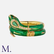 An Important Snake Bangle in 18ct yellow gold in articulated sections with green enamel. Set with