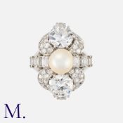 BOUCHERON. A Pearl and Diamond Ring with box. Set with two round transitional cut diamonds above