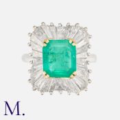 A Colombian Emerald & Diamond Ballerina Ring in 18ct white and yellow gold, set with an emerald-