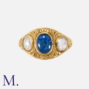 An Antique Sapphire And Diamond Three Stone Ring in yellow gold, set with a principal cabochon