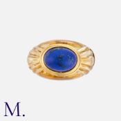 BOUCHERON. A Citrine & Lapis Ring in 18k yellow gold, of bombe form, set with a carved citrine