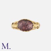 An Antique Pink Sapphire Ring in yellow gold, set with a faceted, foil backed pink sapphire to an