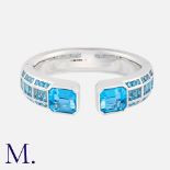 A Blue Topaz Bangle in 18k white gold, the hinged bangle set with square, baguette and octagonal cut