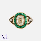 An Old Cut Diamond And Emerald Target Ring in yellow gold, set principally with an old cut diamond