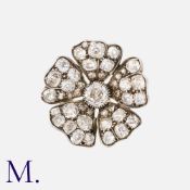 An Antique Old Cut Diamond Flower Brooch in yellow gold and silver, set with old cut diamonds