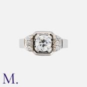 An Art Deco Diamond Ring in 18ct white gold. Set to the centre with a round cut diamond of