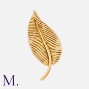 GEORGES LENFANT FOR MAUBOUSSIN. A Gold Leaf Brooch in 18ct yellow gold with tightly woven gold