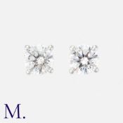 A Pair Of Diamond Stud Earrings in 18k white gold, each set with a round cut diamond of