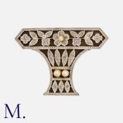 An Art Deco Onyx, Diamond And Pearl Brooch in 18k white gold of openwork floral design backed with
