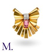 A French Pink Spinel And Diamond Brooch in 18k yellow gold, of bow form, set with a principal