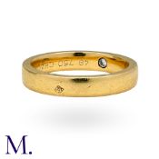 CHAUMET. A Gold Band with Hidden Diamond in 18K yellow gold, set with a small brilliant cut