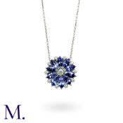 A Tanzanite And Diamond Pendant Necklace in 18k white gold, set with marquise cut tanzanite and