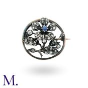 A Sapphire and Diamond Flower Brooch in 18k yellow gold and silver, the floral form set with a round