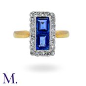 A Sapphire And Diamond Ring in 18k yellow gold, the rectangular form set principally with two step