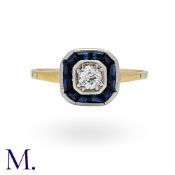 A Sapphire And Diamond Ring in yellow gold and platinum, set centrally with a round cut diamond of