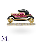 A Novelty Ruby, Diamond And Onyx And Enamel Car Brooch in 18k yellow gold, designed as a car, the
